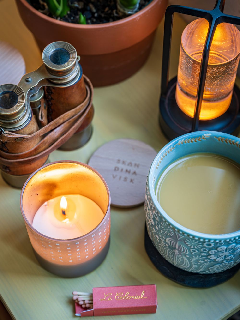 A candle, coffee & binoculars at the Hygge Chalet by Denver Hospitality, Travel & Tourism photographer Captain Colorado Photography.