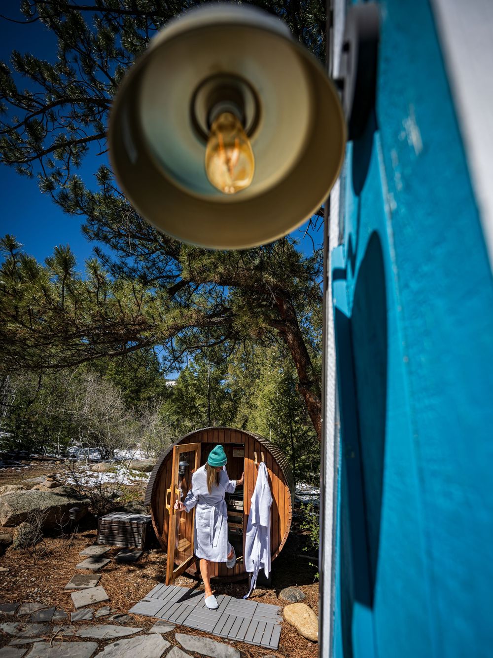 A woman exiting the sauna at the Hygge Chalet by Denver Hospitality, Travel & Tourism photographer Captain Colorado Photography.