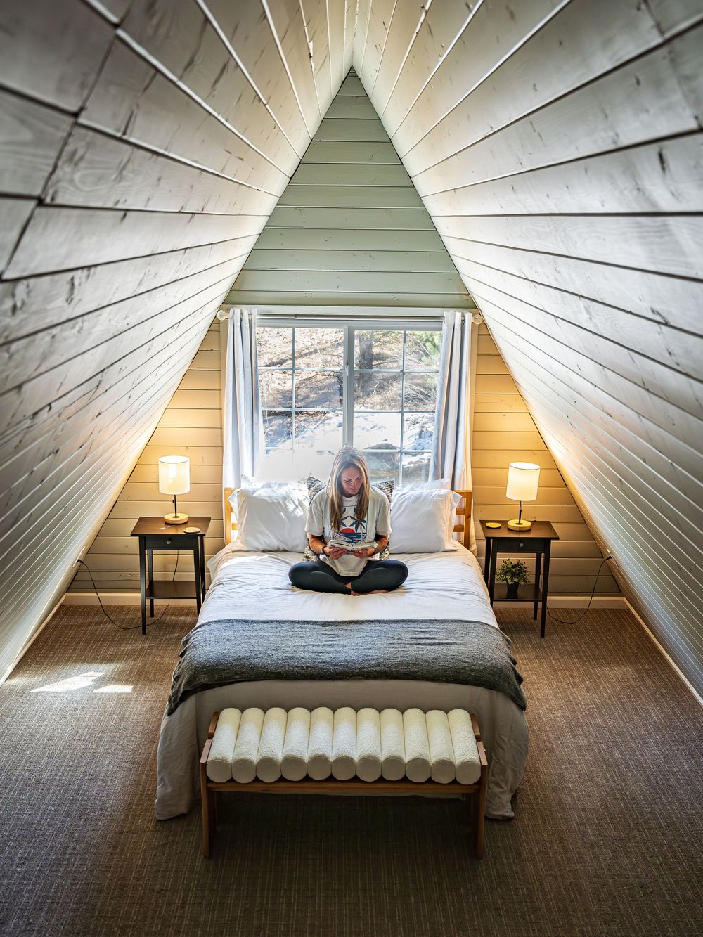 A woman enjoying a book at the Hygge Chalet by Denver Hospitality, Travel & Tourism photographer Captain Colorado Photography.