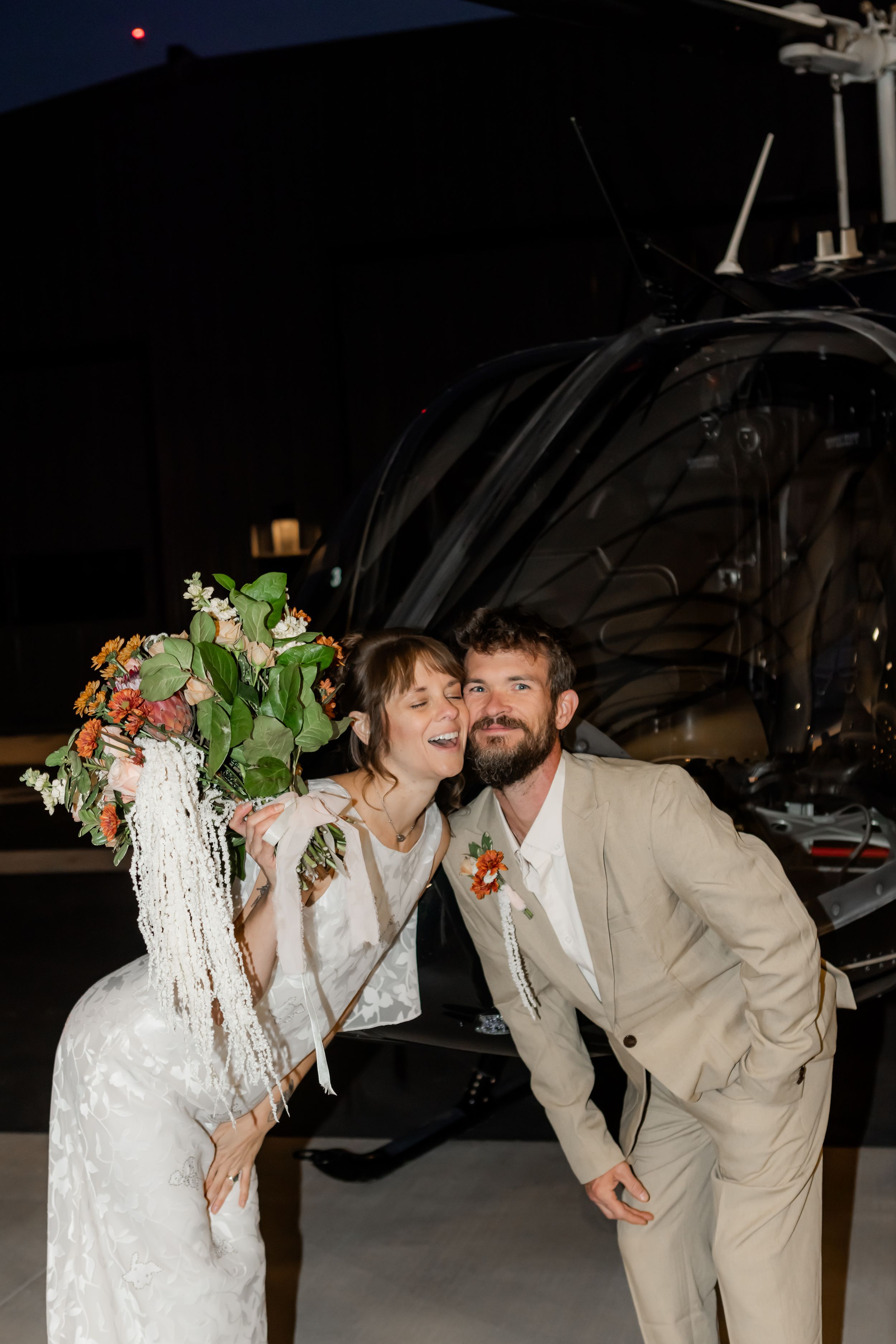 Newlyweds celebrating together after a Utah wedding, photographed at night with joyful energy