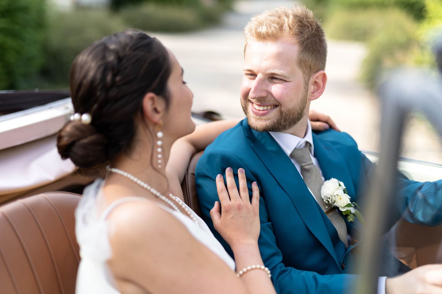 Intimate wedding couple moment captured during outdoor photo session.
