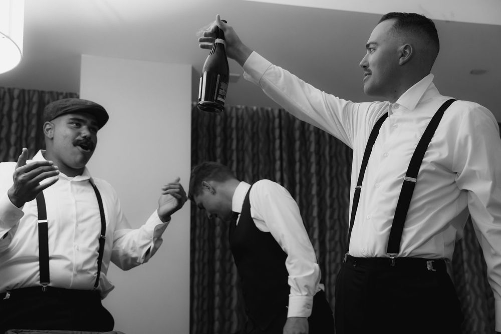 Black and white photos show groomsmen getting ready for a wedding with suspenders and formal attire.