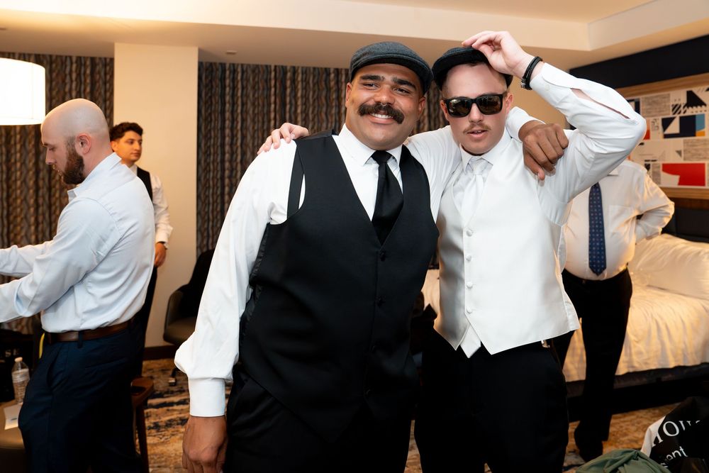 A sequence of candid moments showing wedding party members getting ready and celebrating in a hotel room.