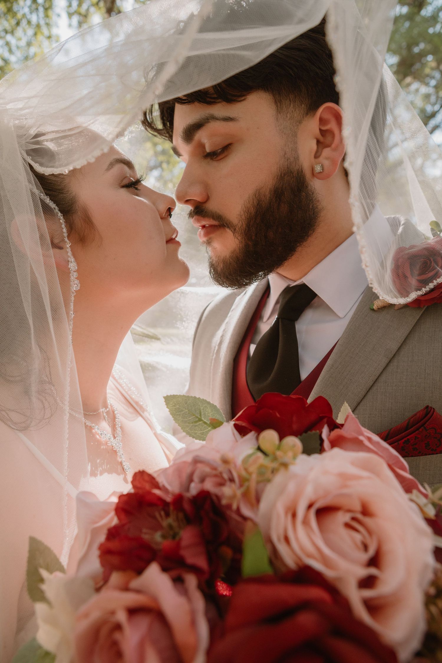 Couple under a veil during golden hour portraits from a Wedding ceremony in Central Texas