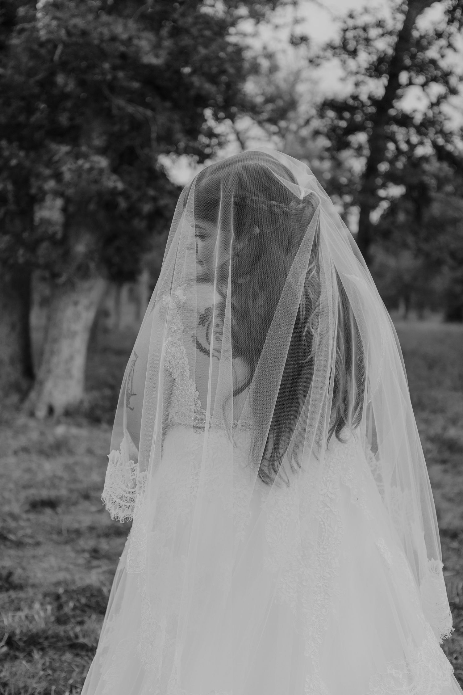 Couple under a veil during golden hour portraits from a Wedding ceremony in Central Texas