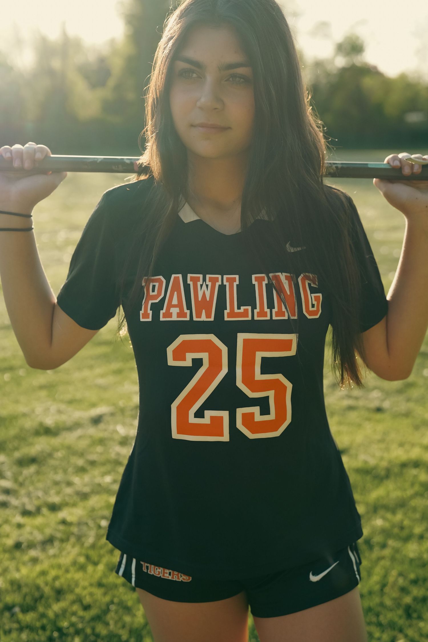 Sports uniform with 'Pawling 25' text photographed in golden hour lighting on athletic field.