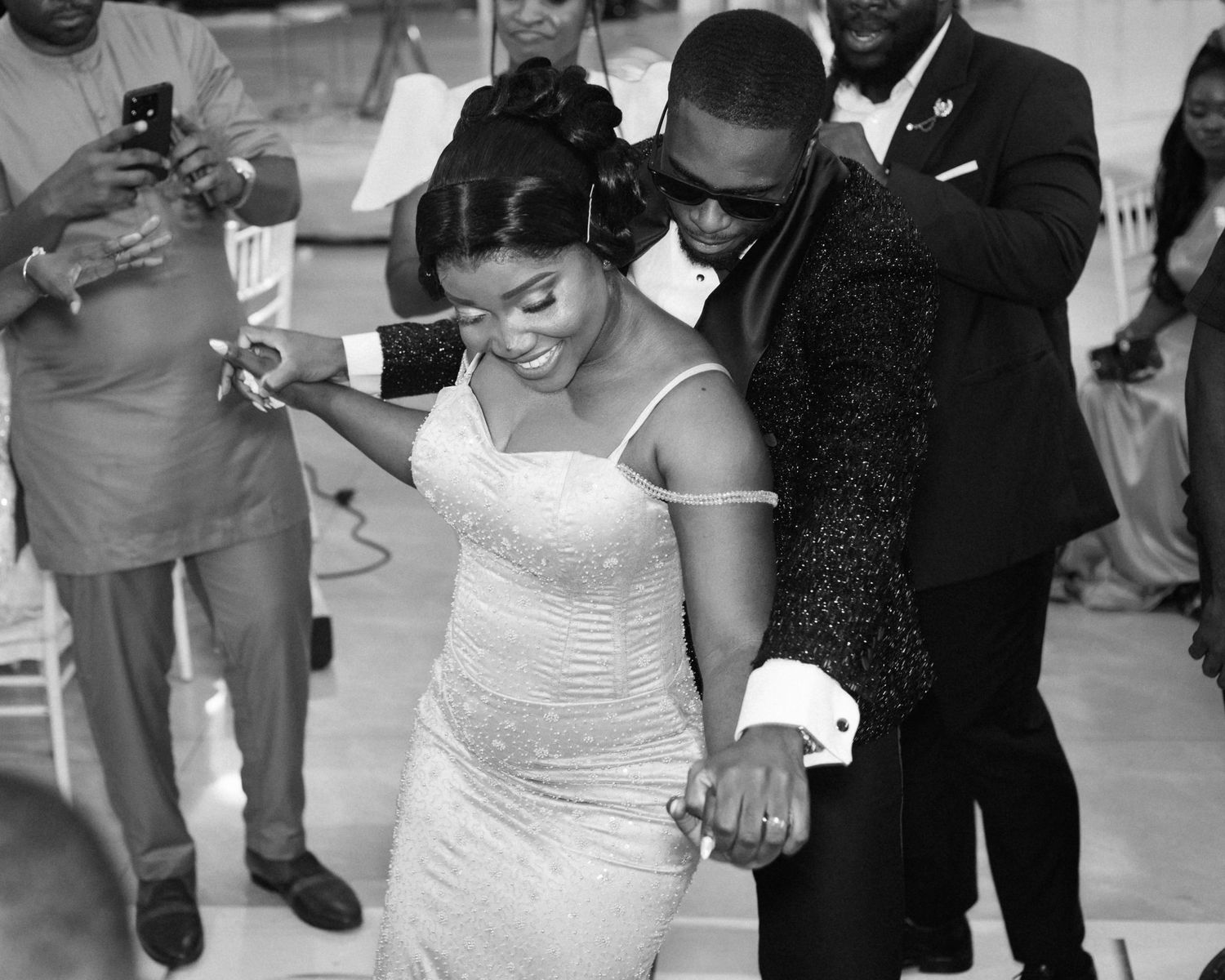 Wedding couple sharing a romantic dance moment on the reception floor.