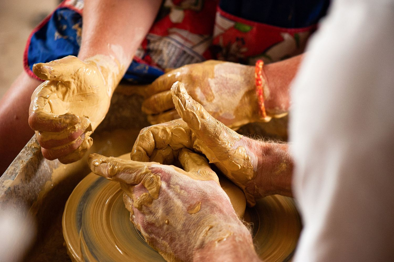 Close-up of hands covered in clay during a workshop at Camp Creative Bellingen