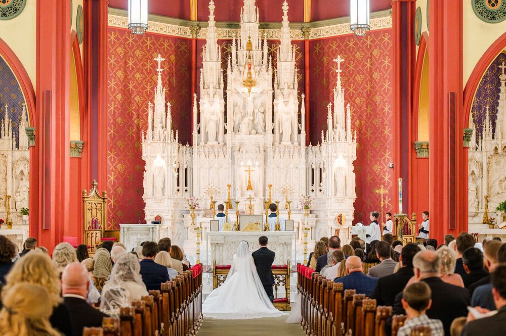 Bride and groom kneeling during their Traditional Latin Mass wedding at Holy Family Cathedral in Tulsa, Oklahoma.