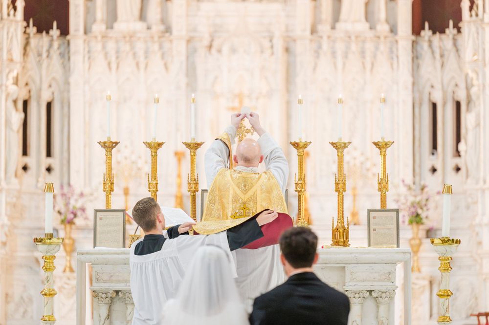 Priest elevates the Host for the Consecration during a wedding mass at Holy Family Cathedral in Tulsa, Oklahoma.