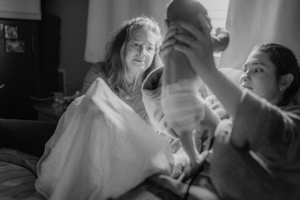 Black and white photograph of a joyful moment during a baby bath.