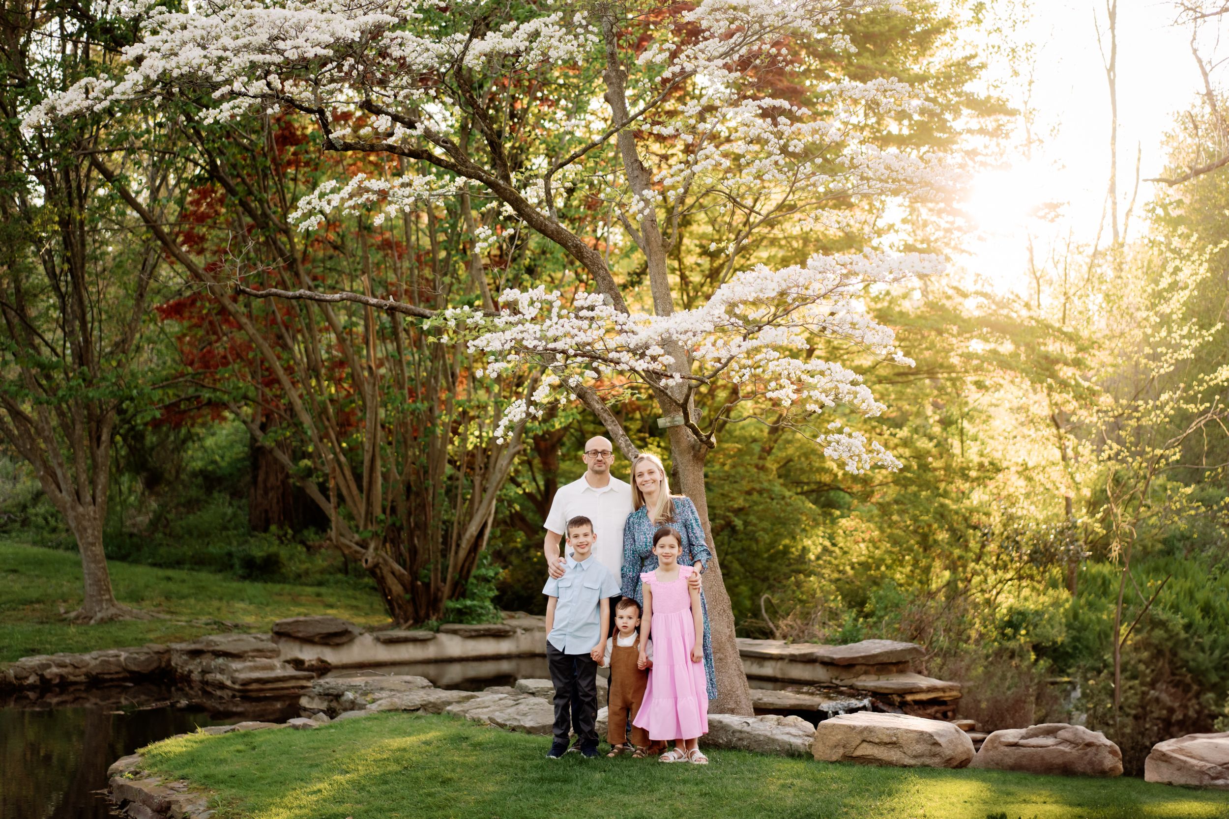 A series of romantic outdoor engagement photos taken at sunset in a lush garden setting with natural light filtering through trees.