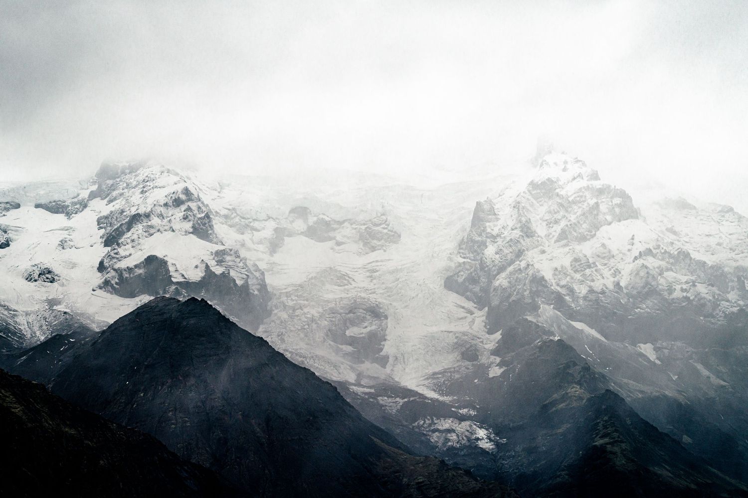 Snow-capped mountain range with misty peaks stretching across the horizon.