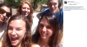 Group of friends taking a cheerful outdoor selfie together on a sunny day.
