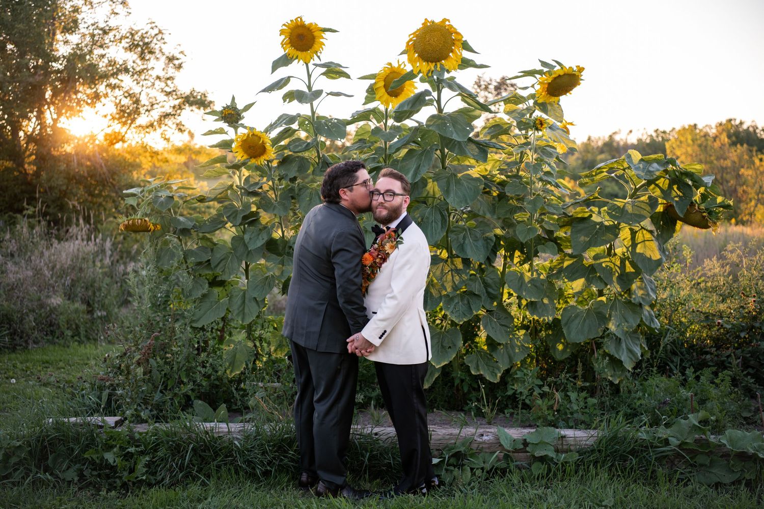 Romantic sunset photoshoot in a field of tall sunflowers during golden hour.