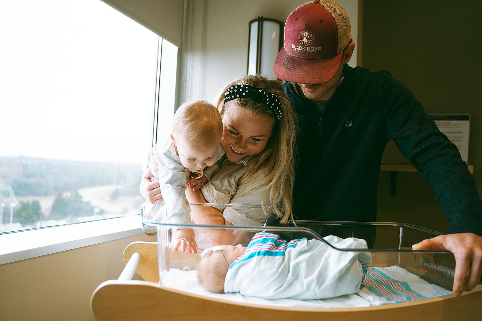 A quiet moment shared in a hospital room with natural light streaming through windows.