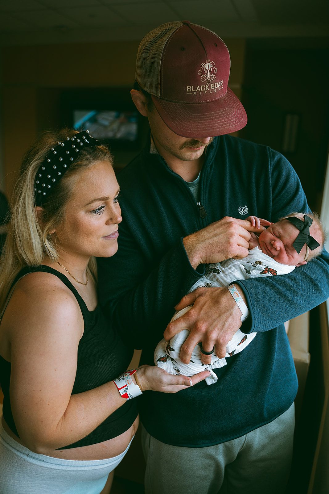 A gentle moment of bonding with a newborn wrapped in a soft blanket.