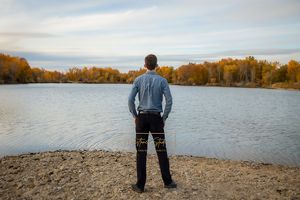 Boise Senior photos Boise white water park Boy standing river shore looking at water