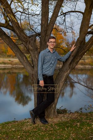 Boise Senior photos Boise white water park. Boy posing with tree