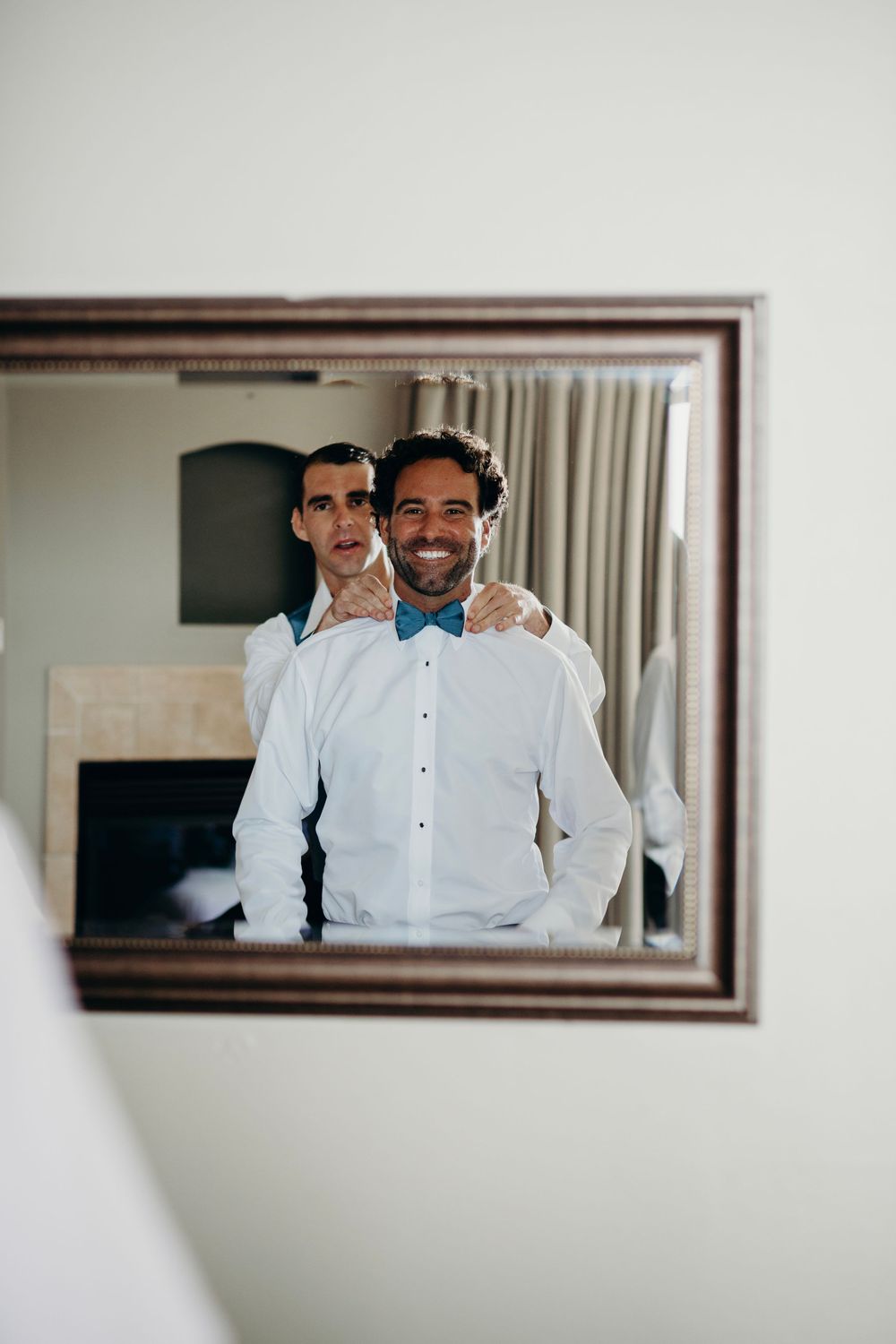 A series of mirror reflections showing people in white dress shirts preparing for a formal event.