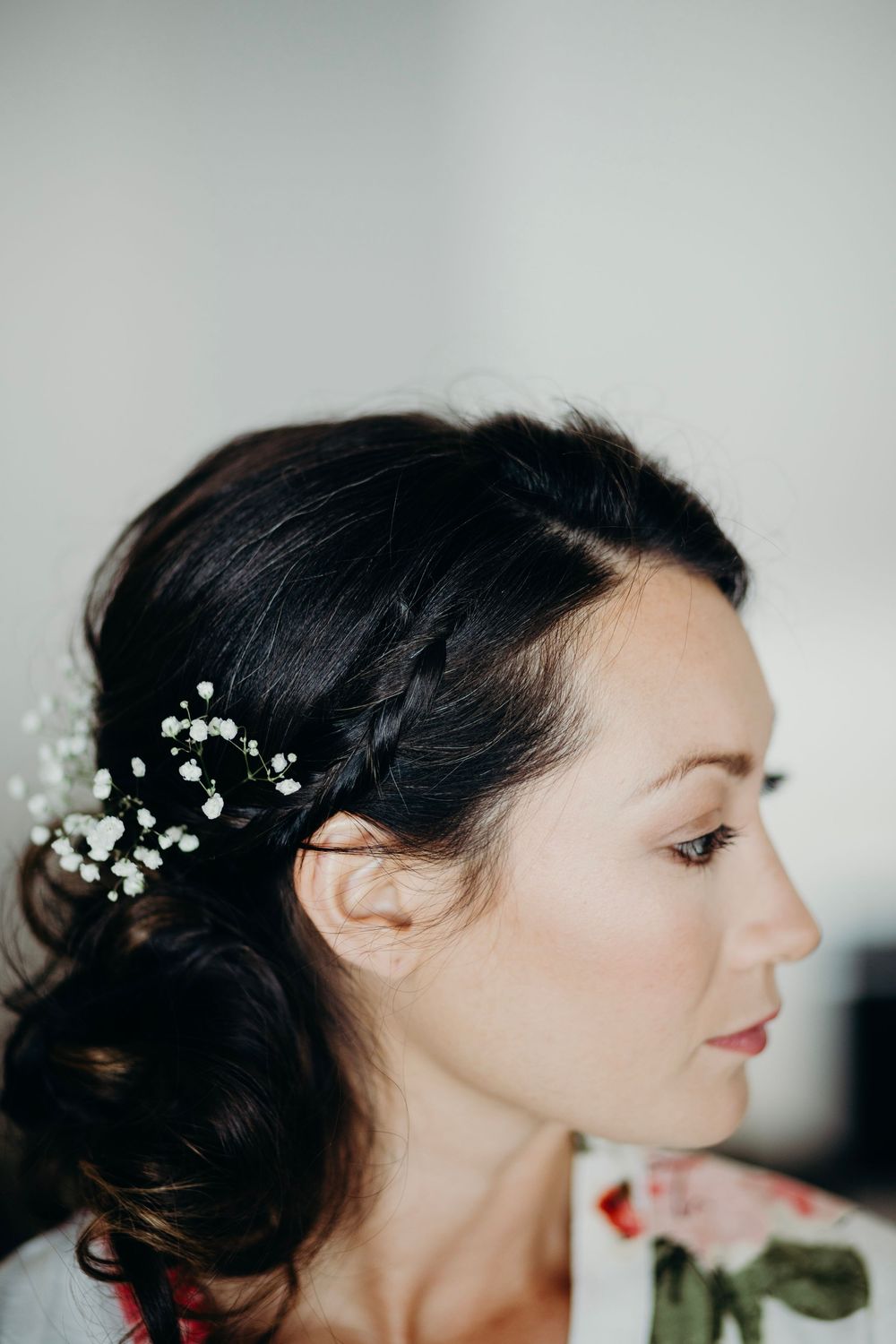 A sequence of profile views showing a woman with dark hair and delicate floral hair accessories.
