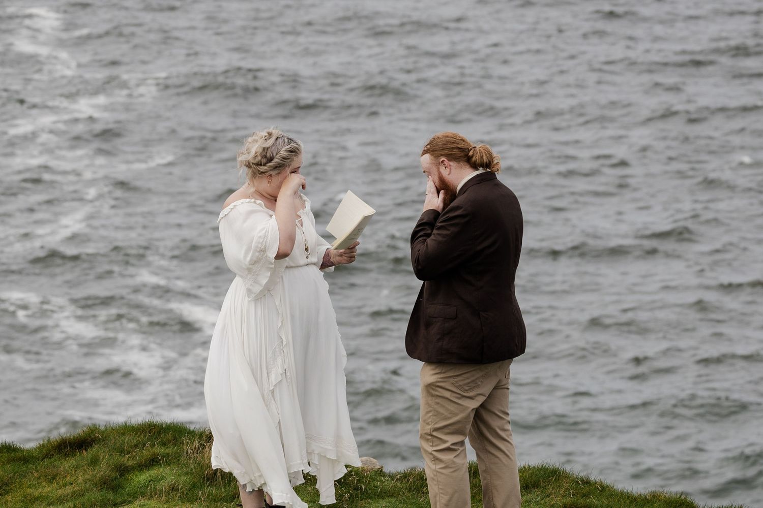 Emotional vow exchange during Ireland destination elopement ceremony at Doolin Cliff Walk, Cliffs of Moher