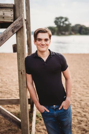A series of casual outdoor portraits taken on a sandy beach with wooden posts in the background.