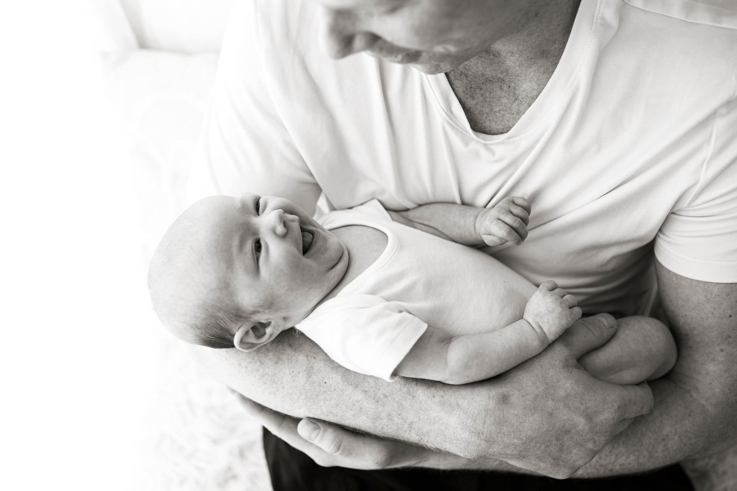 newborn baby in fathers arms by little wonderland photography widnes cheshire