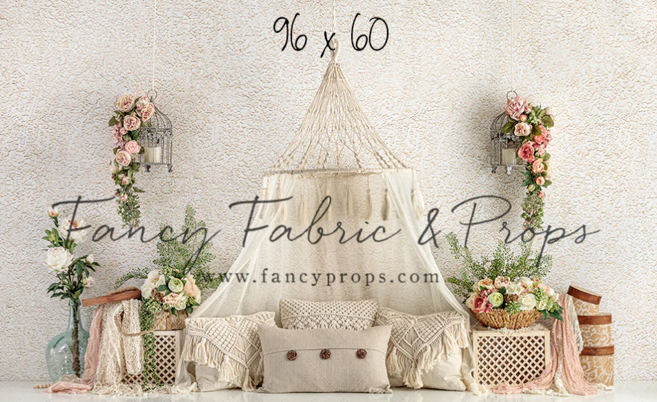 Elegant boho wedding backdrop with macrame hanging, floral arrangements, and rustic decor against neutral wall.
