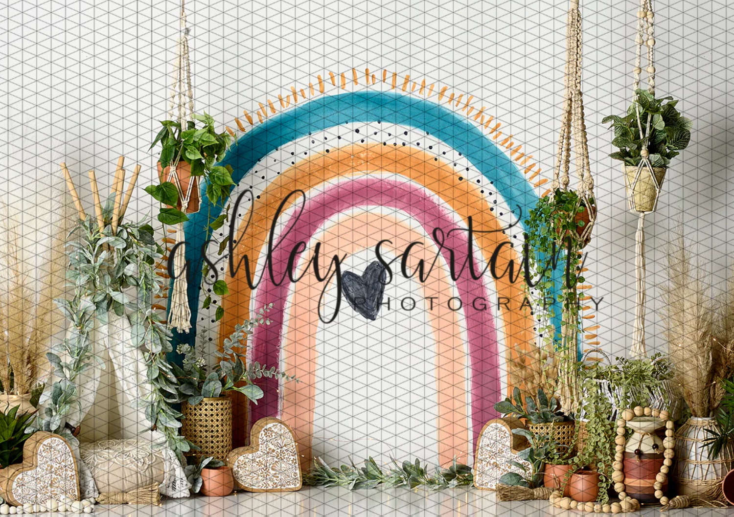 A rustic wedding arch with dried flowers and pampas grass decorations against a white wall with potted plants.