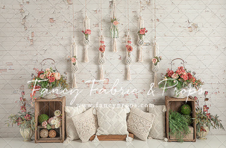 Vintage wedding decor with white brick wall, pink roses, and rustic wooden crates creates a romantic shabby chic atmosphere.