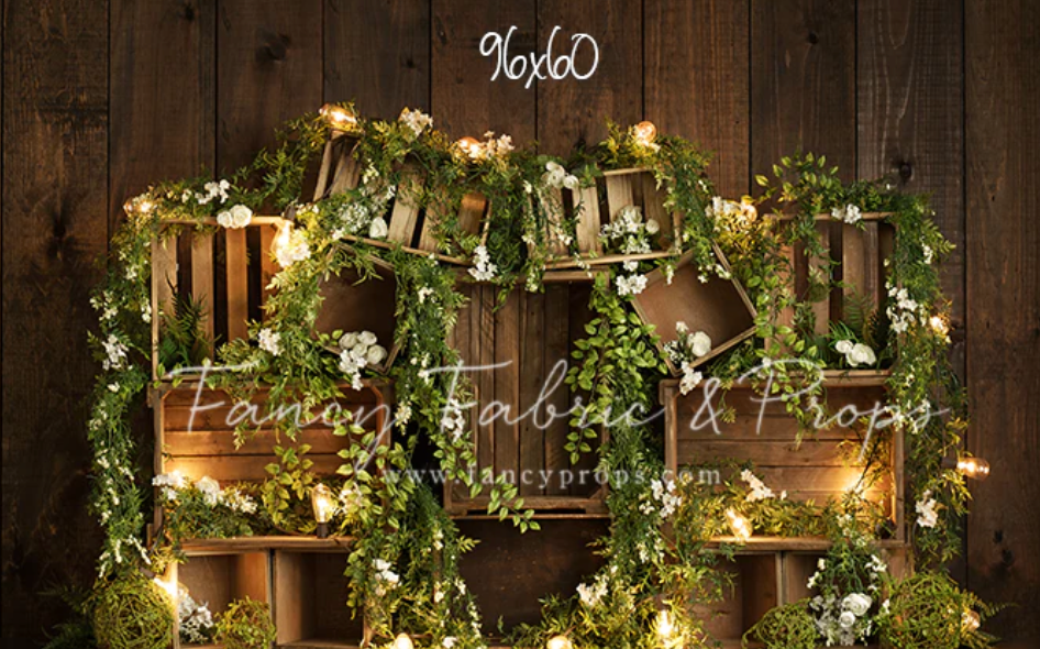 Rustic wooden barn interior decorated with twinkling lights and floral garlands for an elegant wedding reception.