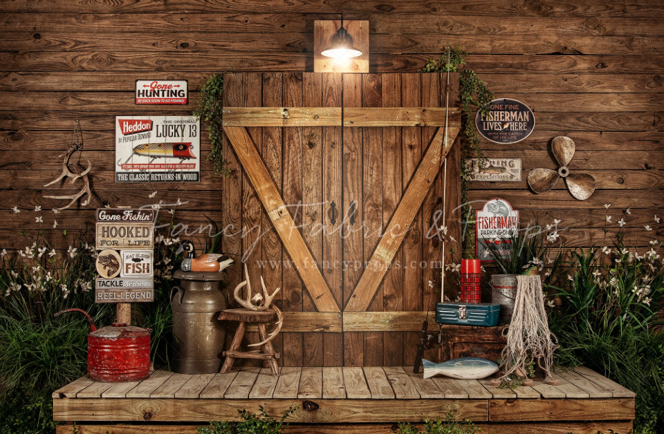 Rustic wooden barn door backdrop with vintage decor, milk jugs, warning signs and lanterns on wooden platform.