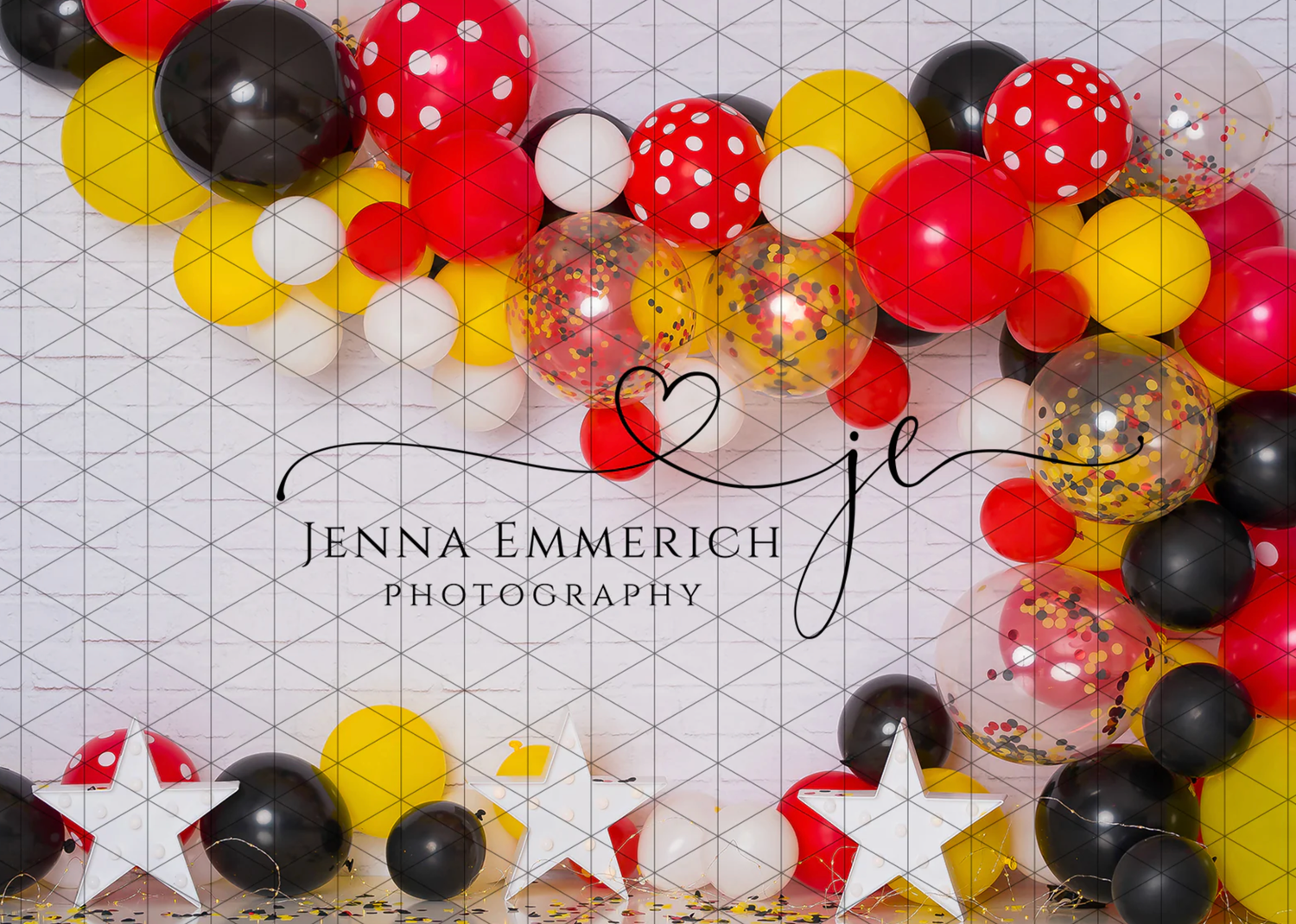 Festive balloon arch decoration featuring red, black, and yellow balloons with polka dots and star accents.