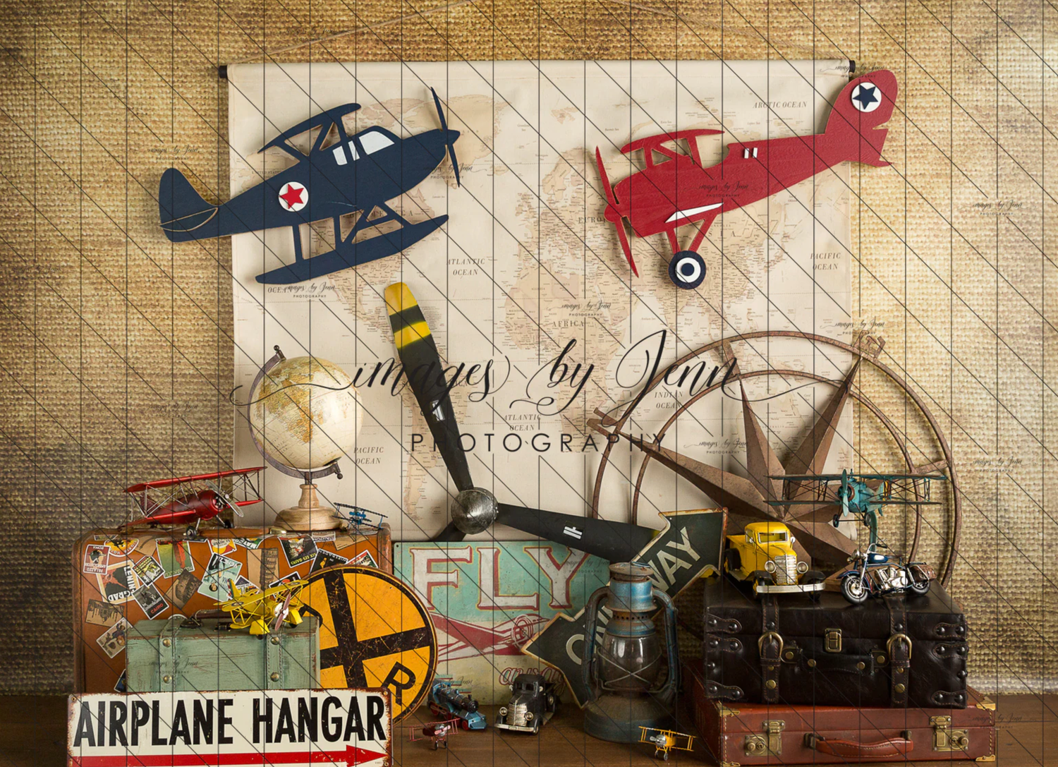Vintage aviation themed display with toy planes, airplane hangar sign, and antique decor against textured background.