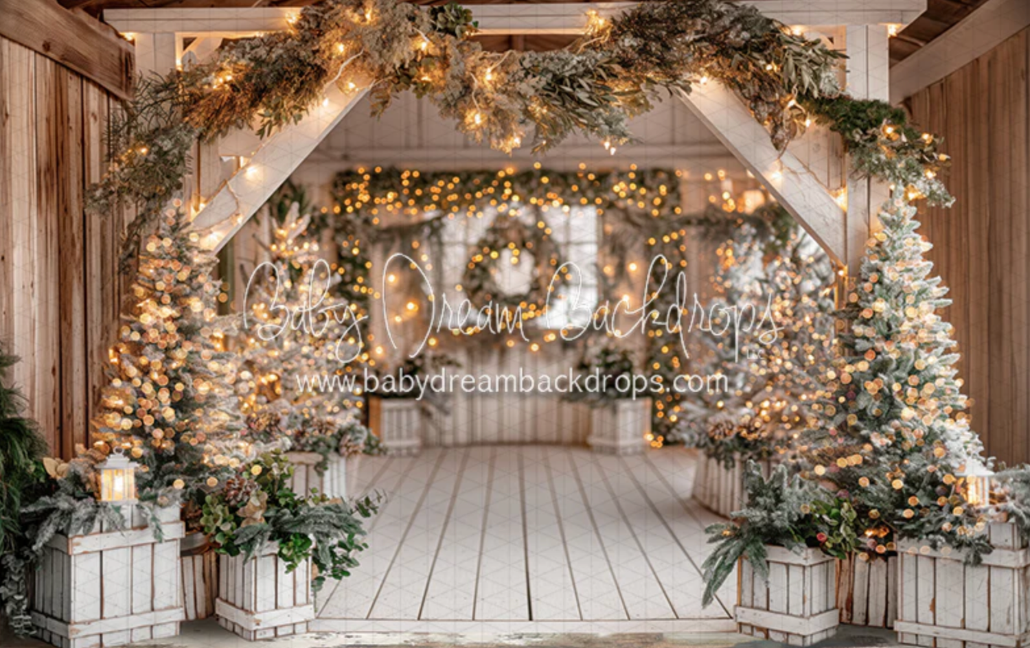 Rustic wooden barn interior decorated with twinkling lights and lush greenery garlands for a wedding venue.