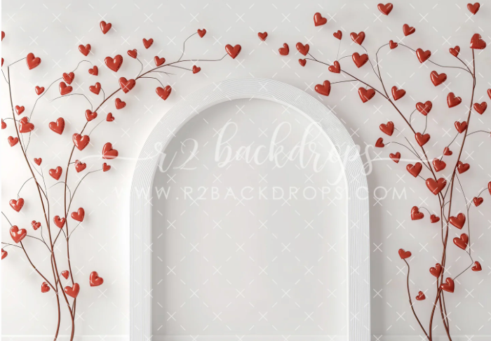 White arched doorways with delicate red heart branches creating a romantic Valentine's Day themed background design.