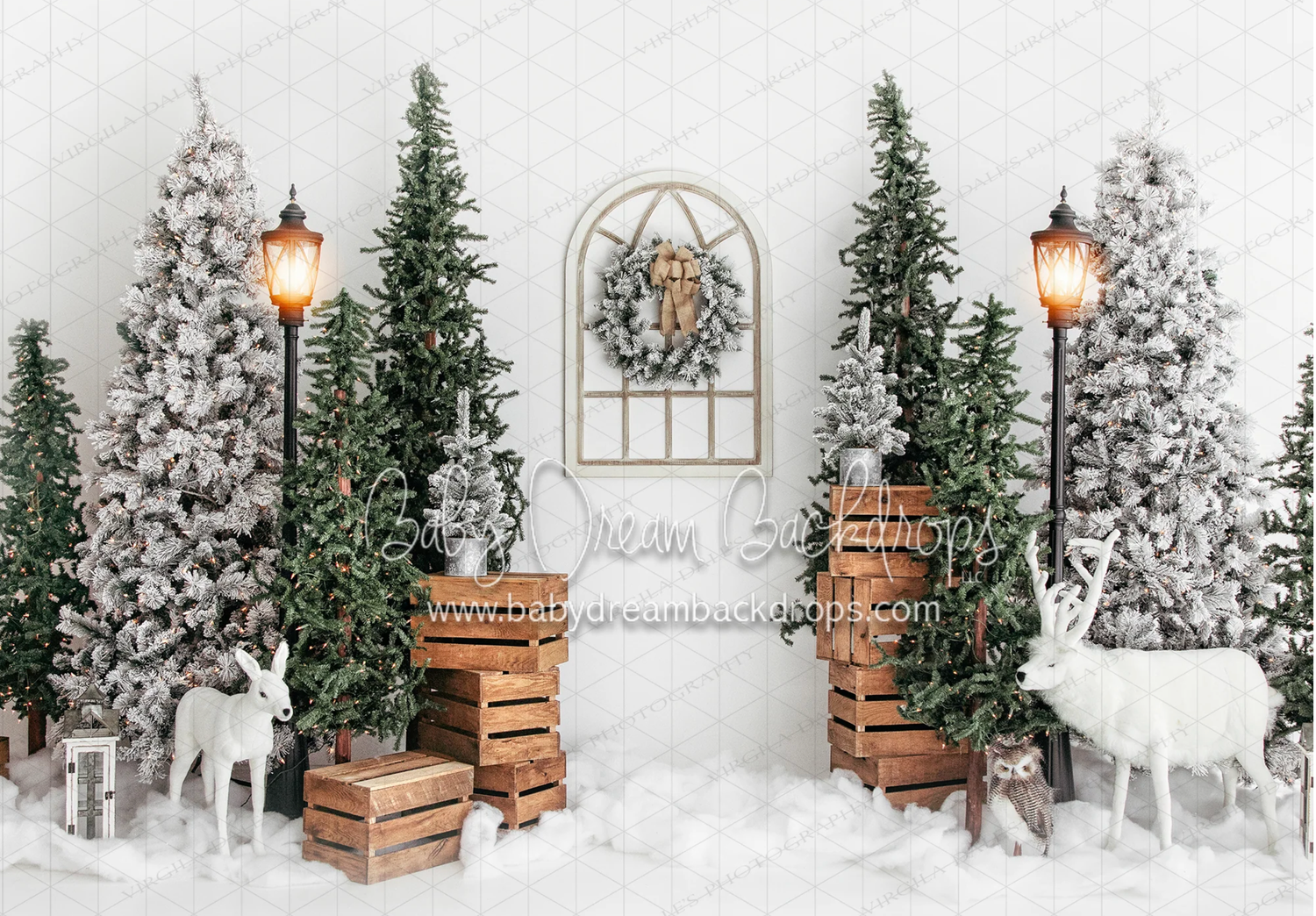 Winter wonderland photo backdrop with snow covered evergreen trees, wooden crates, and glowing lanterns.