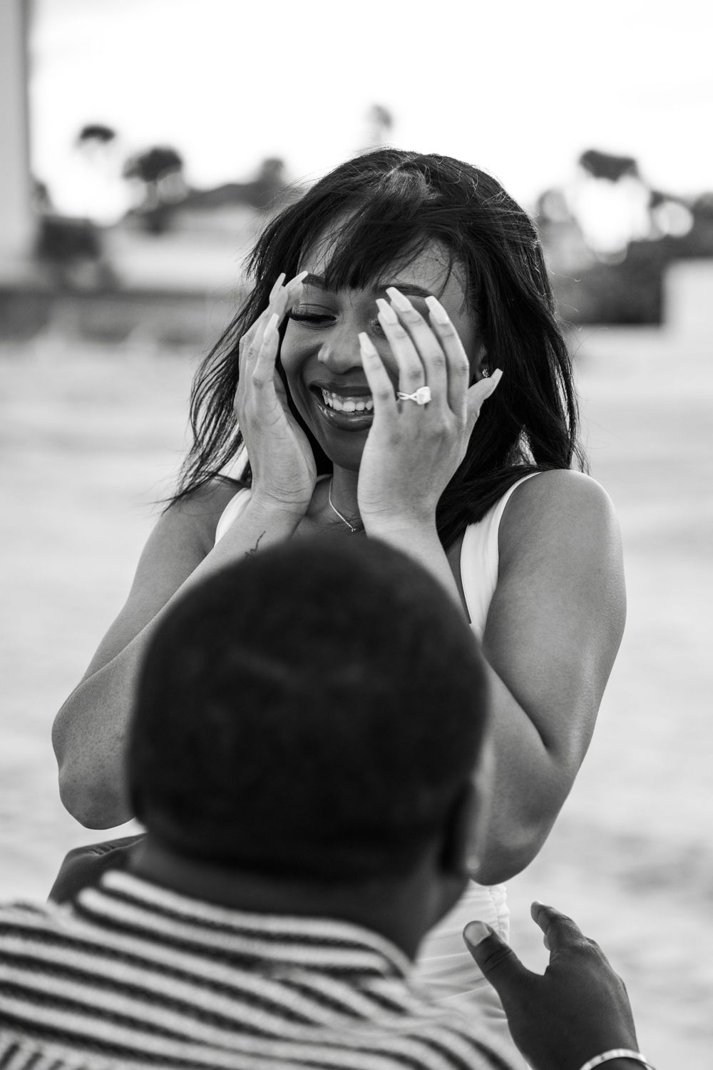 A black and white photo sequence shows someone wearing a striped shirt covering their face with their hands in Daytona Beach, Florida