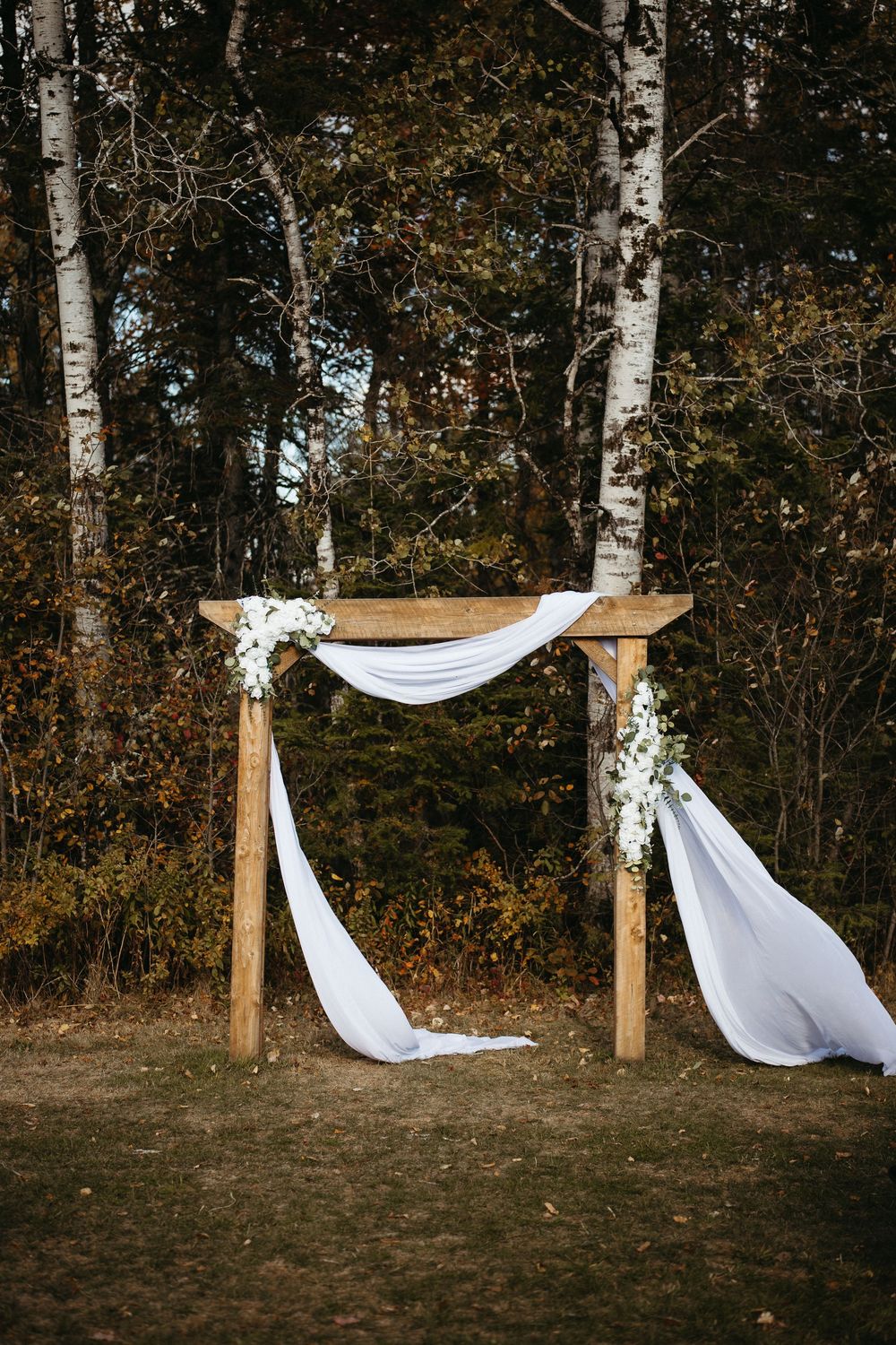 simple rustic wedding arch ceremony decor at Ticklebelly Hill, barn wedding in New Brunswick wedding photographer Bates Barn wedding photos