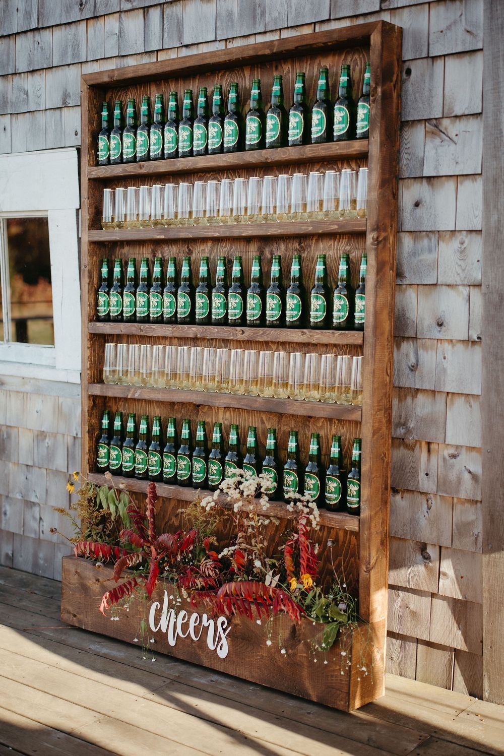 Champagne toast beer wall wedding decor at Ticklebelly Hill, rustic barn wedding photography in autumn wedding photographer in New Brunswick