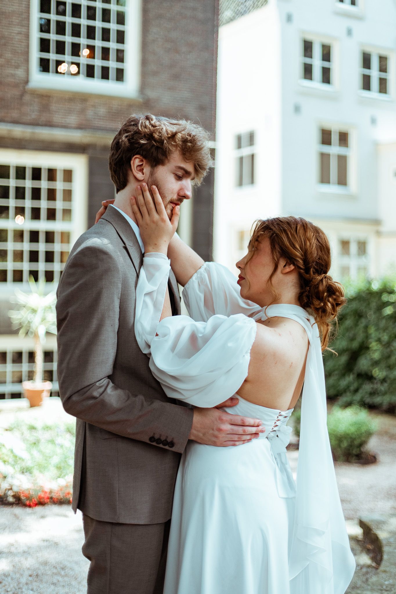 Wedding couple in formal attire sharing an intimate dance moment together in garden in Amsterdam.