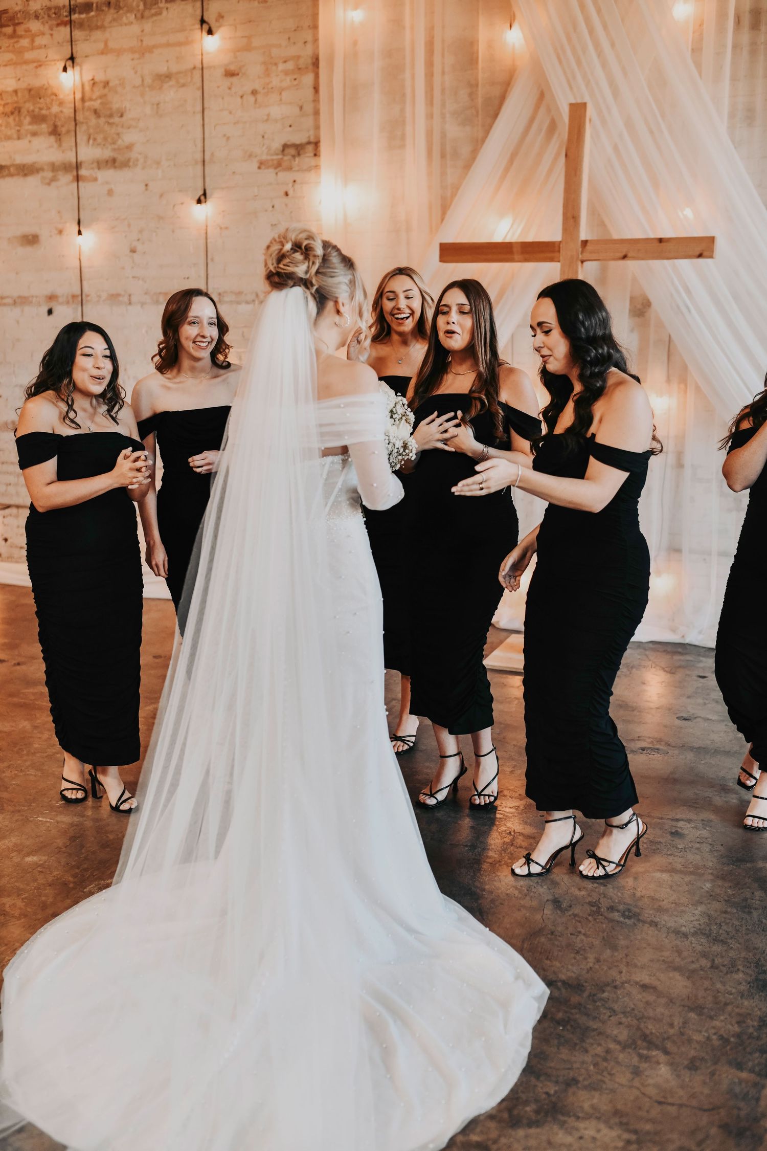 Bridal party reacting to bride in her gown before ceremony