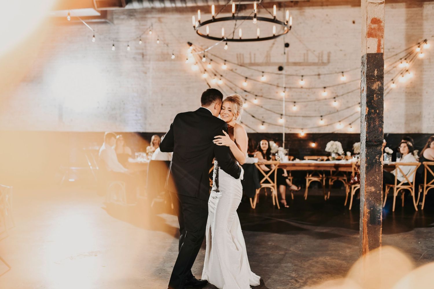 Newlyweds dancing during first dance at reception