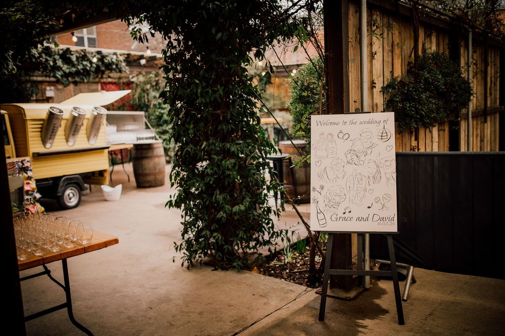 Rustic outdoor wedding venue with wooden beams and string lights creating a romantic ambiance.