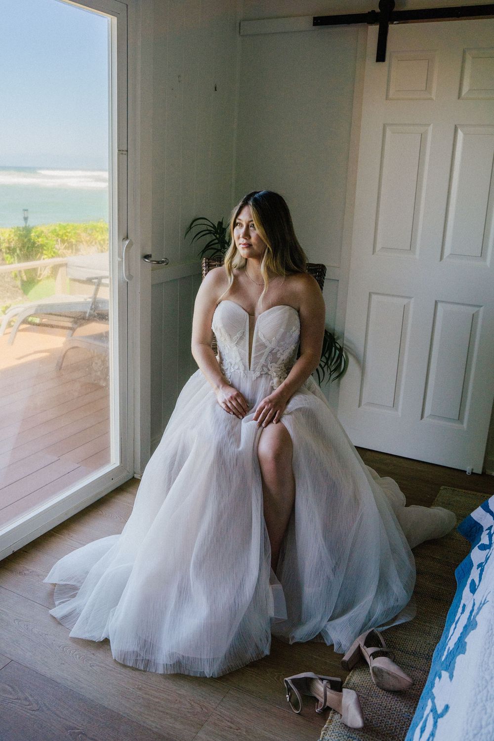 Wedding preparations in a bright room with white dresses and blue accents visible.