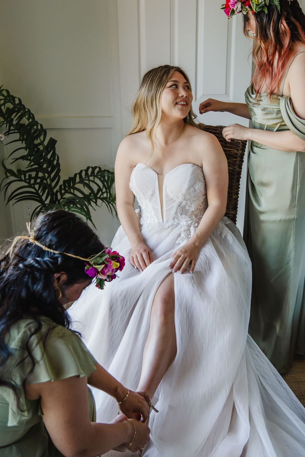 Getting ready moments with wedding dresses and floral accents in an indoor setting.