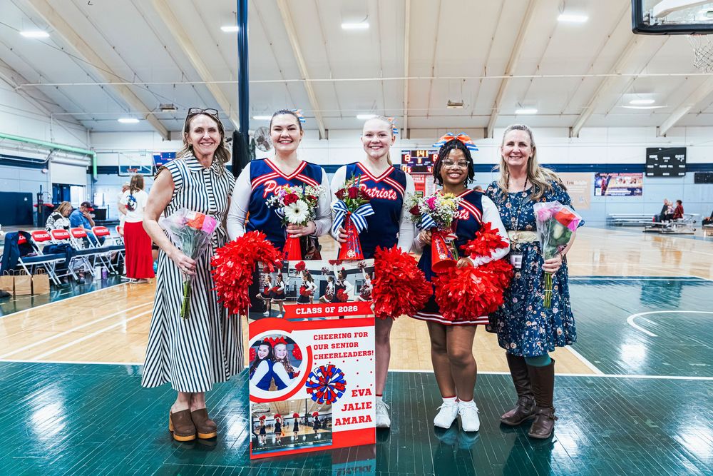 Four people standing together at Senior Night