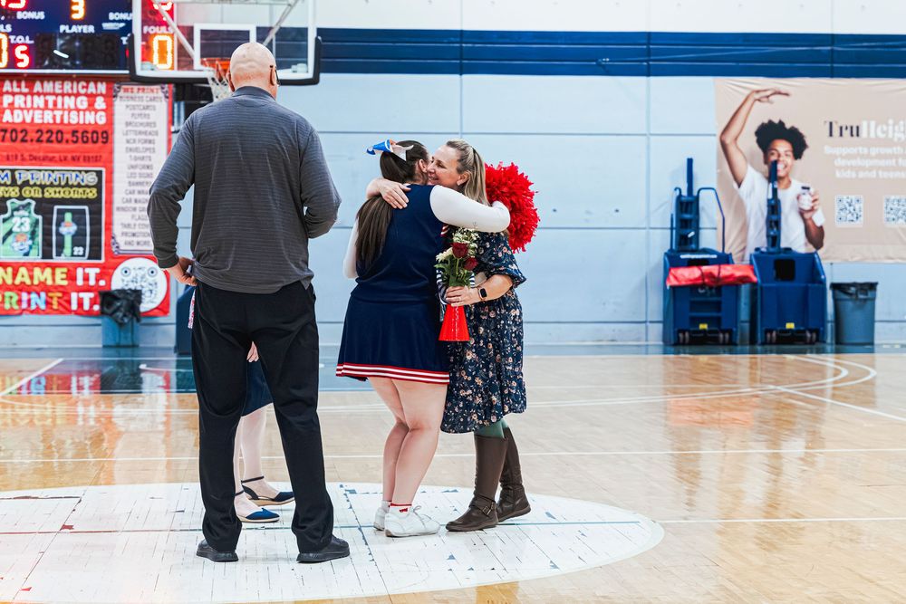 Cheer student and Coach hugging during senior Night