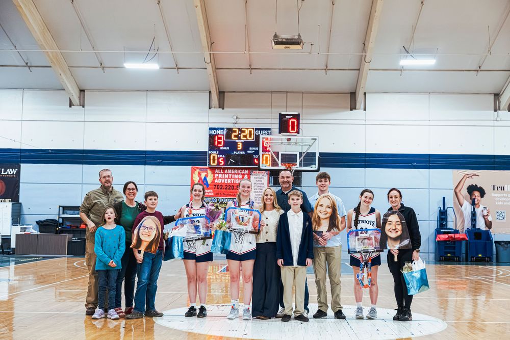 Senior night athletes and family posing for a group photo